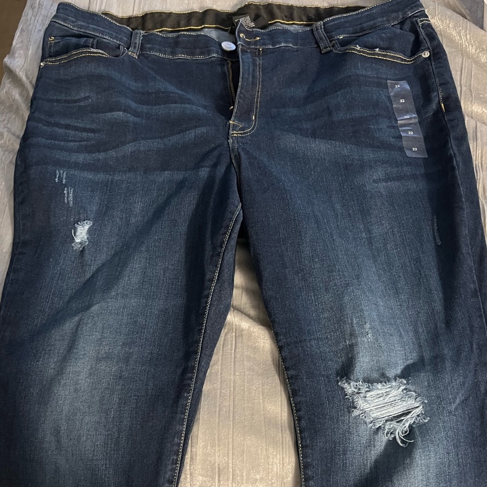Lane Bryant size 22 dark blue jeans with a few rips.